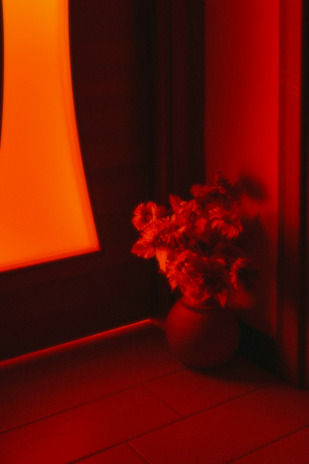 a vase filled with flowers sitting on top of a tiled floor